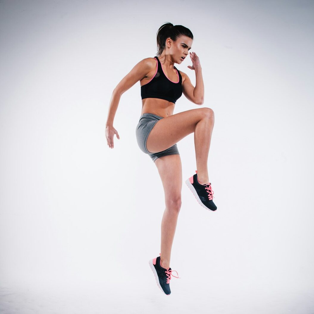 woman jumping near white wall paint